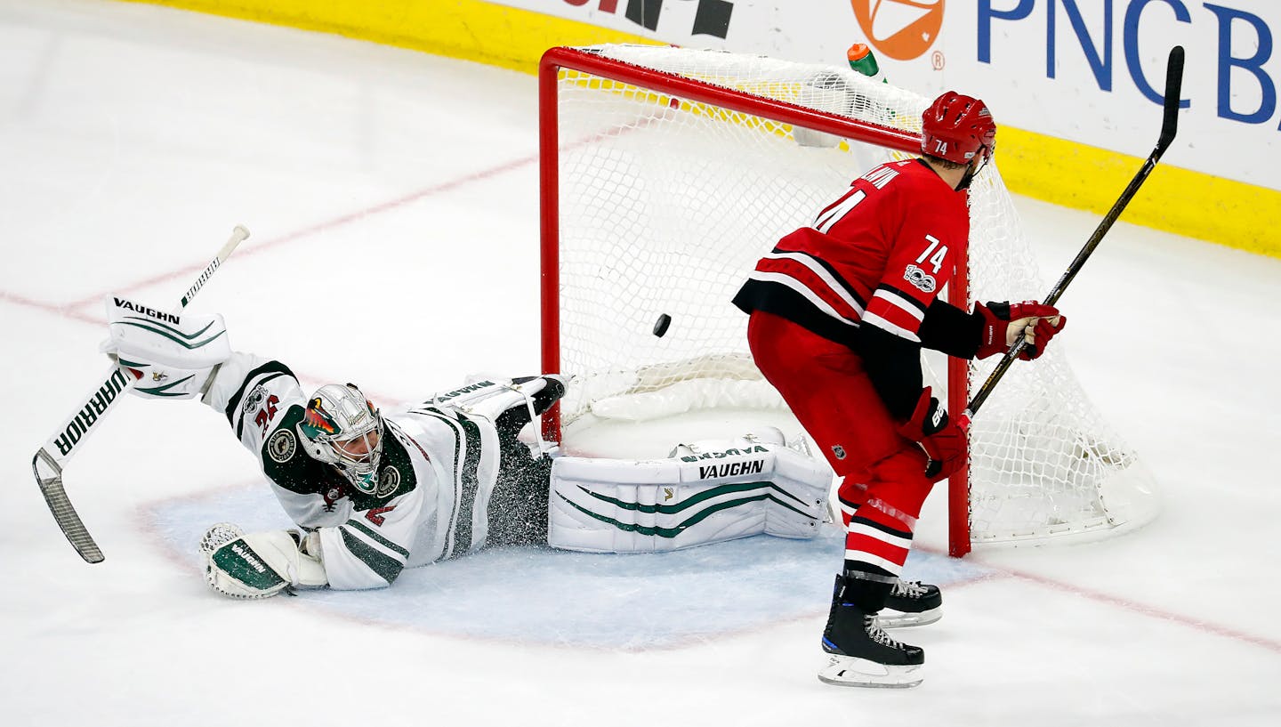 Carolina Hurricanes' Jaccob Slavin (74) shoots the puck past Minnesota Wild goalie Alex Stalock (32) to win the shootout during an NHL hockey game, Saturday, Oct. 7, 2017, in Raleigh, N.C. (AP Photo/Karl B DeBlaker)