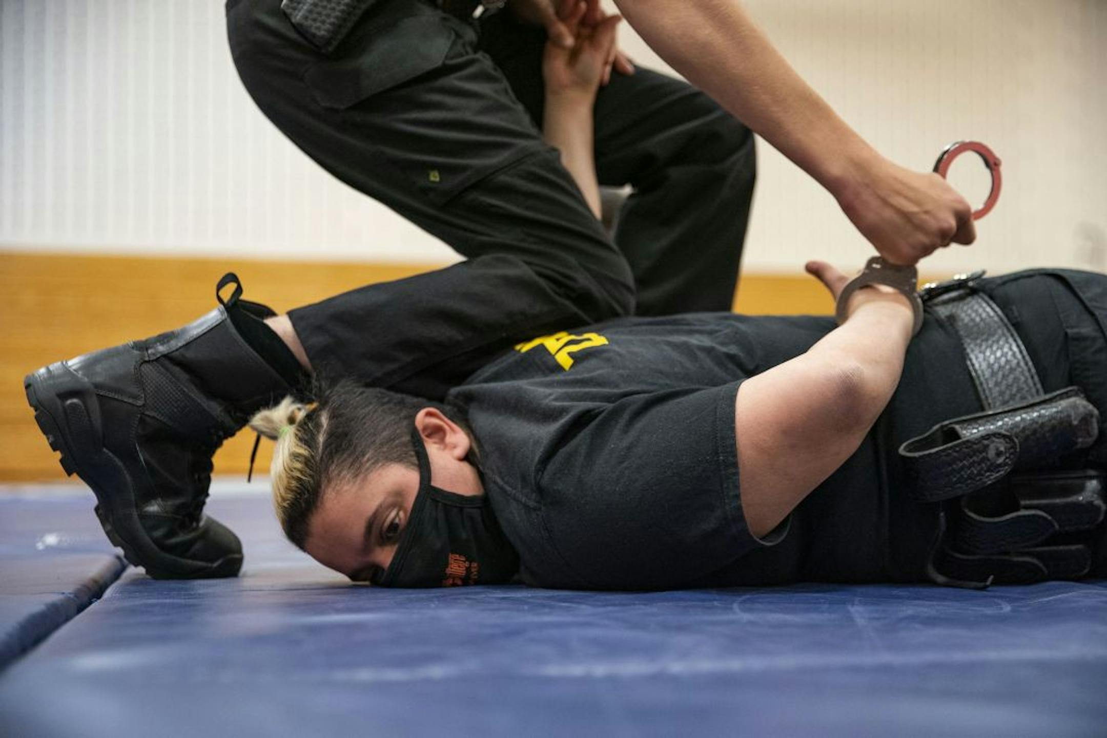 A Law Enforcement trainee practiced handcuffing techniques on Mona Zeidan during defensive tactics class in the gymnasium at Fond Du Lac Tribal and Community College in Cloquet, Minn. on Tuesday November 17, 2020.