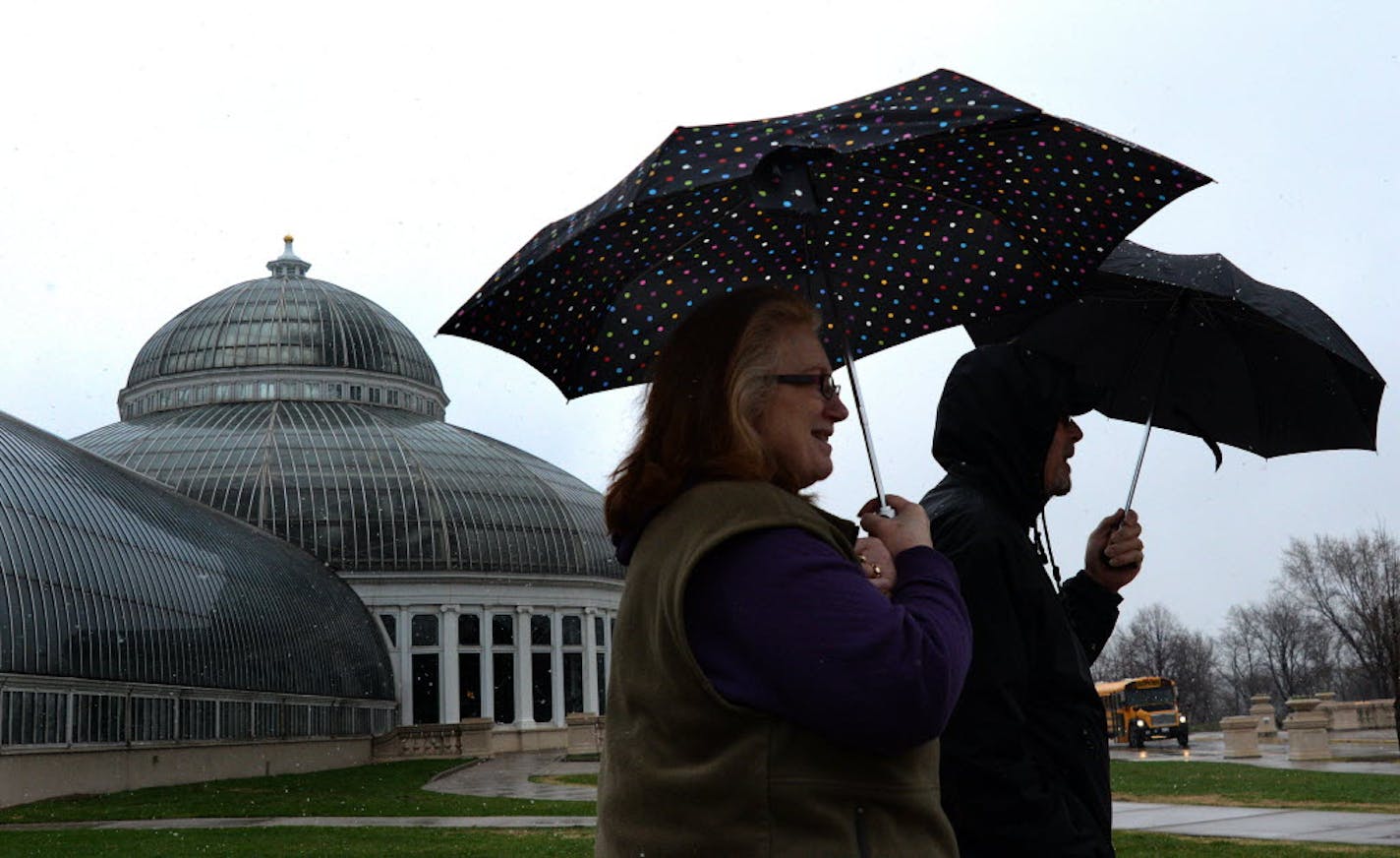 George and Pam Holgate of Cottage Grove visited the Como Zoo on Wednesday sheltered from the sleet with umbrellas.