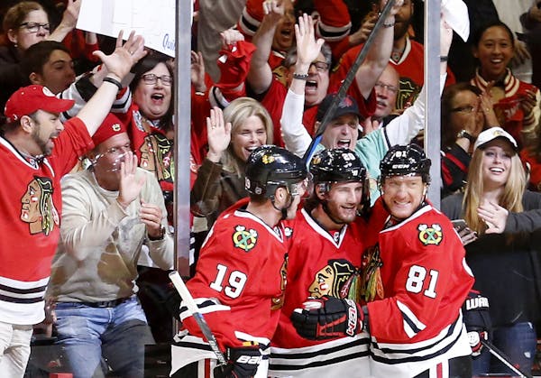 Jonathan Toews (19), Brandon Saad (20) and Marian Hossa (81) celebrated a goal by Saad in the first period.