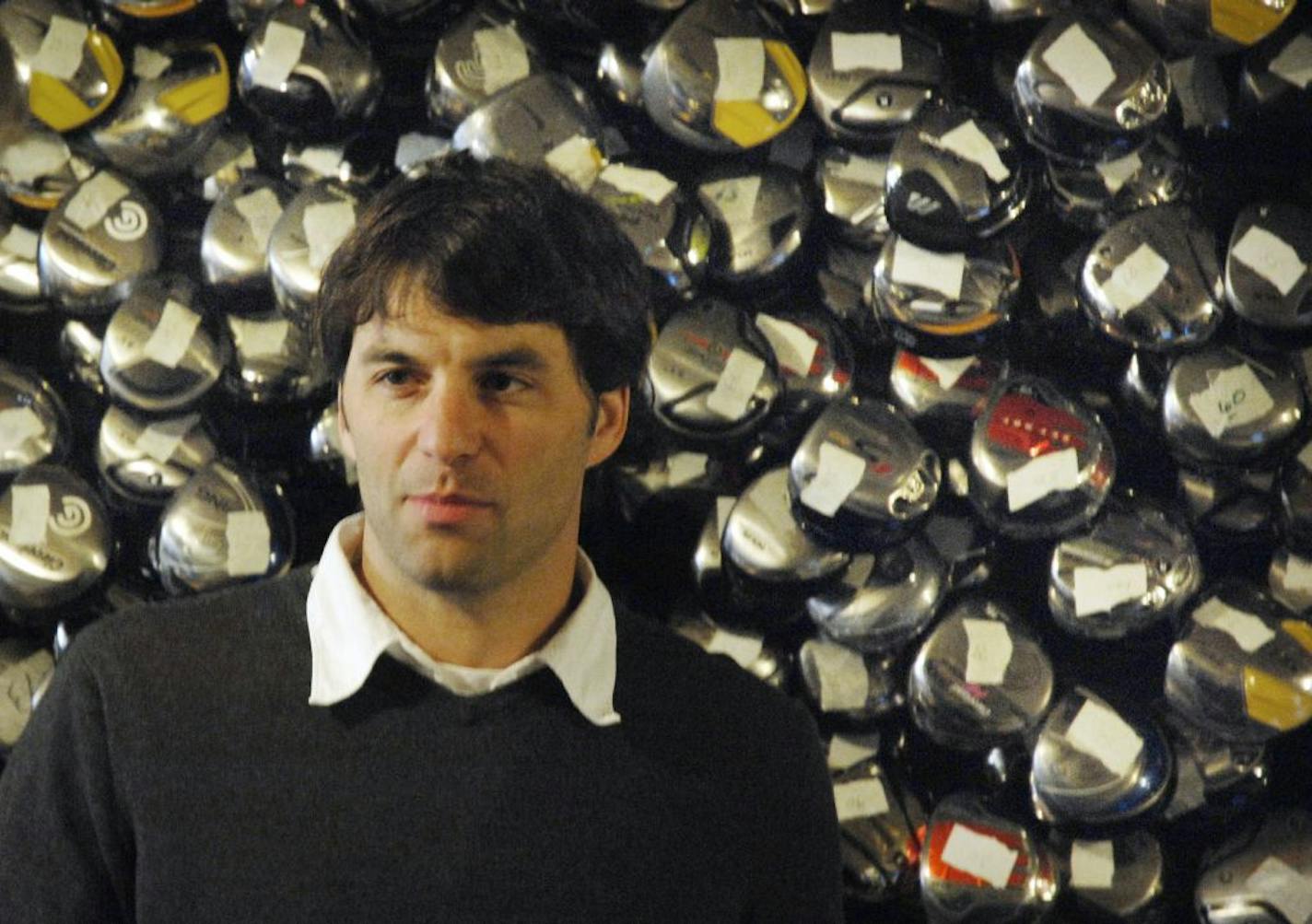 Simon Kallal, co-owner of 2nd Swing Golf with some of the store's inventory in the basement of the Hennepin Ave. store in Minneapolis.