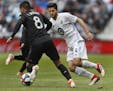 Eric Miller(4) of the Loons(4) defends against Ulises Segura(8).] The Loons take on D.C. United at Allianz Field in St. Paul, MN. RICHARD TSONG-TAATAR