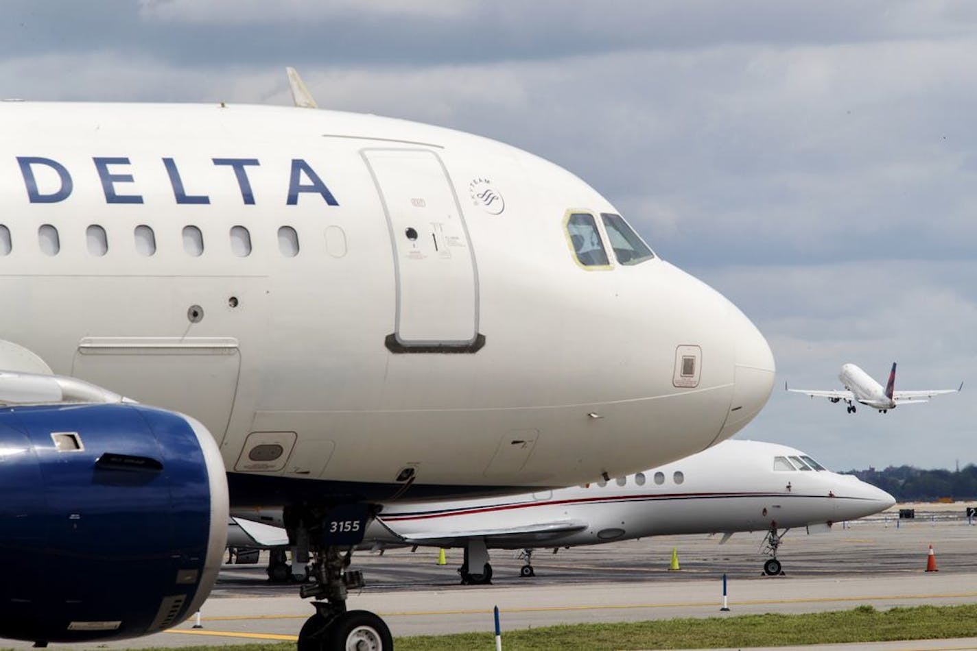 FILE - In this Aug. 8, 2017, file photo, a Delta Air Lines jet waits on the tarmac at LaGuardia Airport in New York. Delta tops an annual study that ranks US airlines by on-time arrivals, complaint rates, and other statistical measurements. Researchers who crunch the numbers say that U.S. airlines are getting better as a whole.