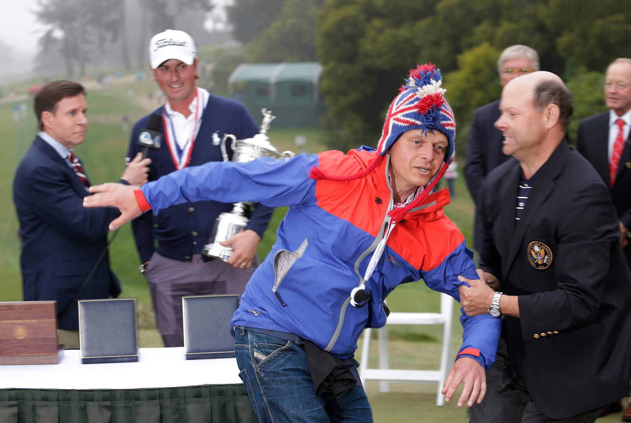 A fans ran in front of Webb Simpson as he is interviewed after winning the U.S. Open on Sunday in San Francisco.