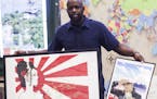 English teacher Bijoun Eric Jordan, who is raising money to plan a trip with students to Japan this summer, shows off art created by current and forme