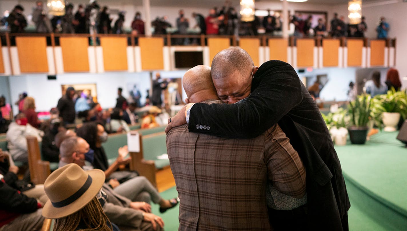 Rep. John Thompson right, hugged the Rev. Jerry McAfee pastor of New Salem Baptist Church during a prayer service for George Floyd family Sunday March 28, 2021 in Minneapolis, MN.] Jerry Holt •Jerry.Holt@startribune.com