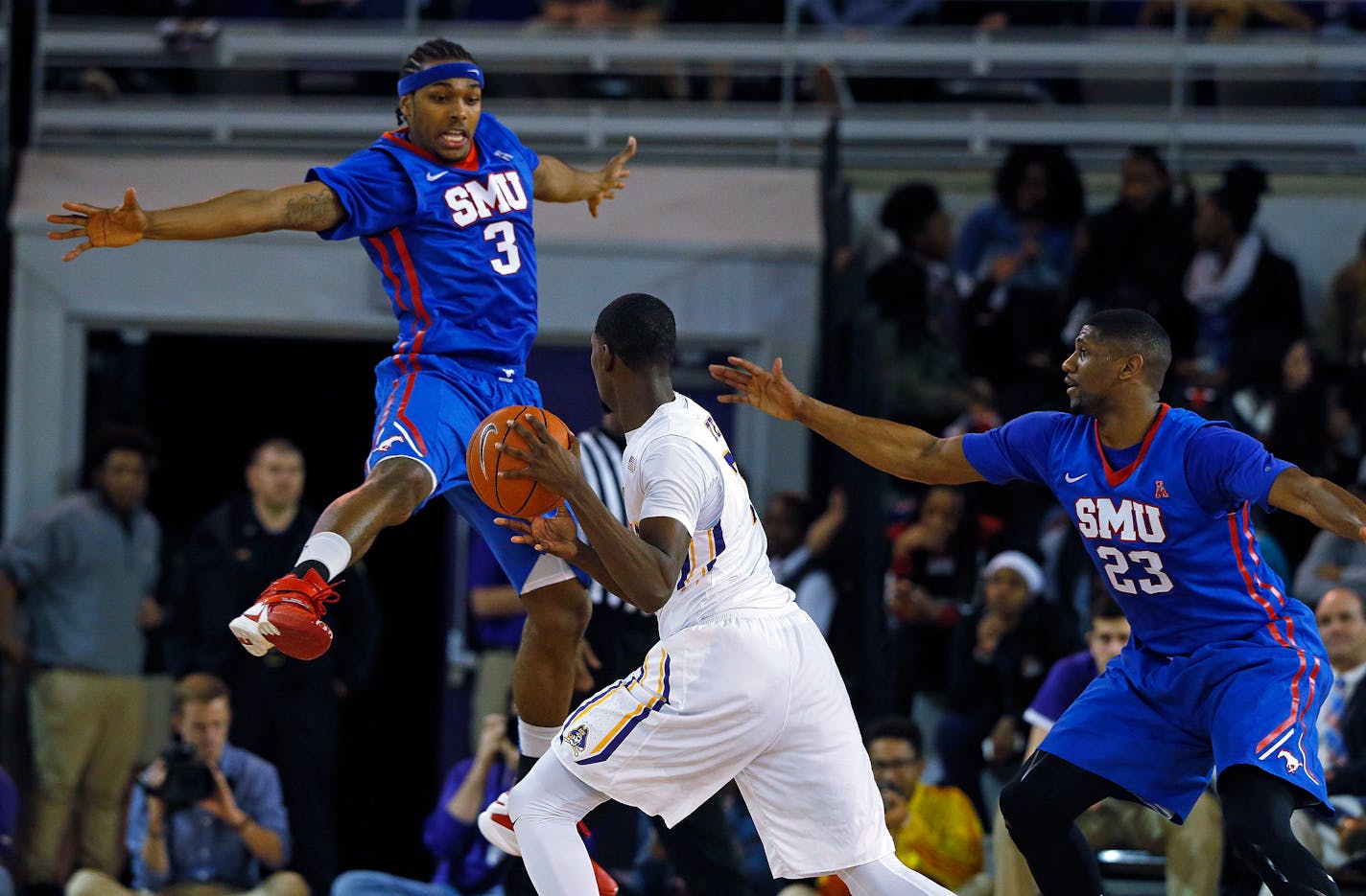 Southern Methodist's Sterling Brown (3) jumps to block the ball of East Carolina's Caleb White (2) with SMU's Jordan Tolbert (23) nearby, during the second half of an NCAA college basketball game in Greenville, N.C., Wednesday, Jan. 13, 2016. SMU won 79-55. (AP Photo/Karl B DeBlaker)