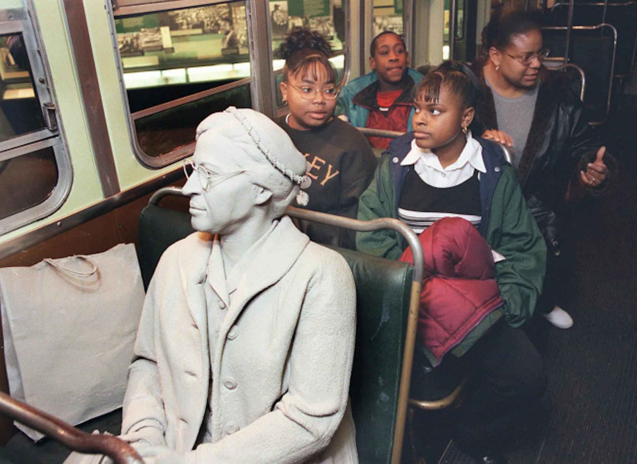 Visitors at the National Civil Rights Museum in Memphis listen as recording of a bus driver "threatens" figure of Rosa Parks, left, seated in the front of the bus. T