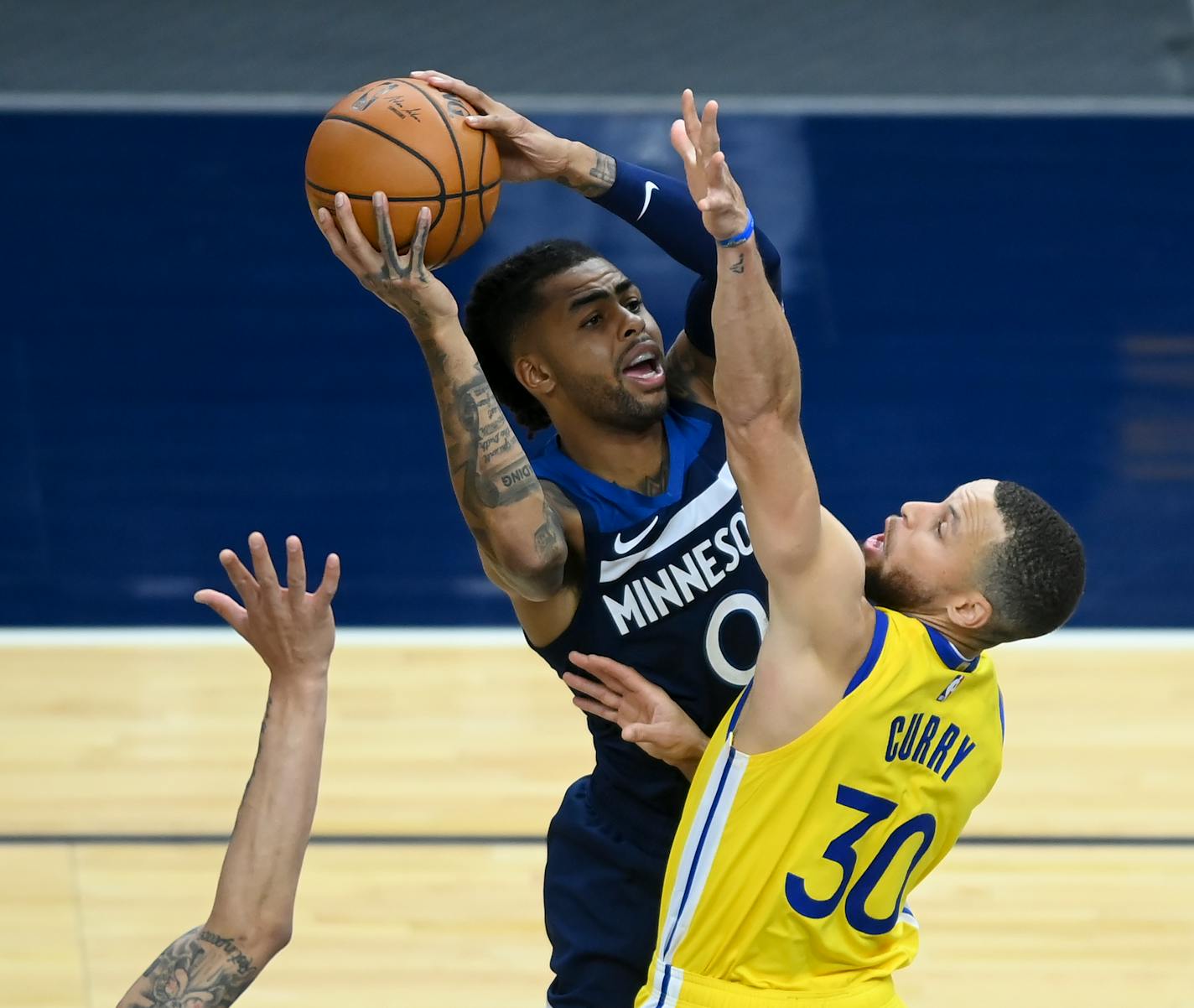 Minnesota Timberwolves guard D'Angelo Russell (0) attempted a shot as he was defended by Golden State Warriors guard Stephen Curry (30) in the second half.