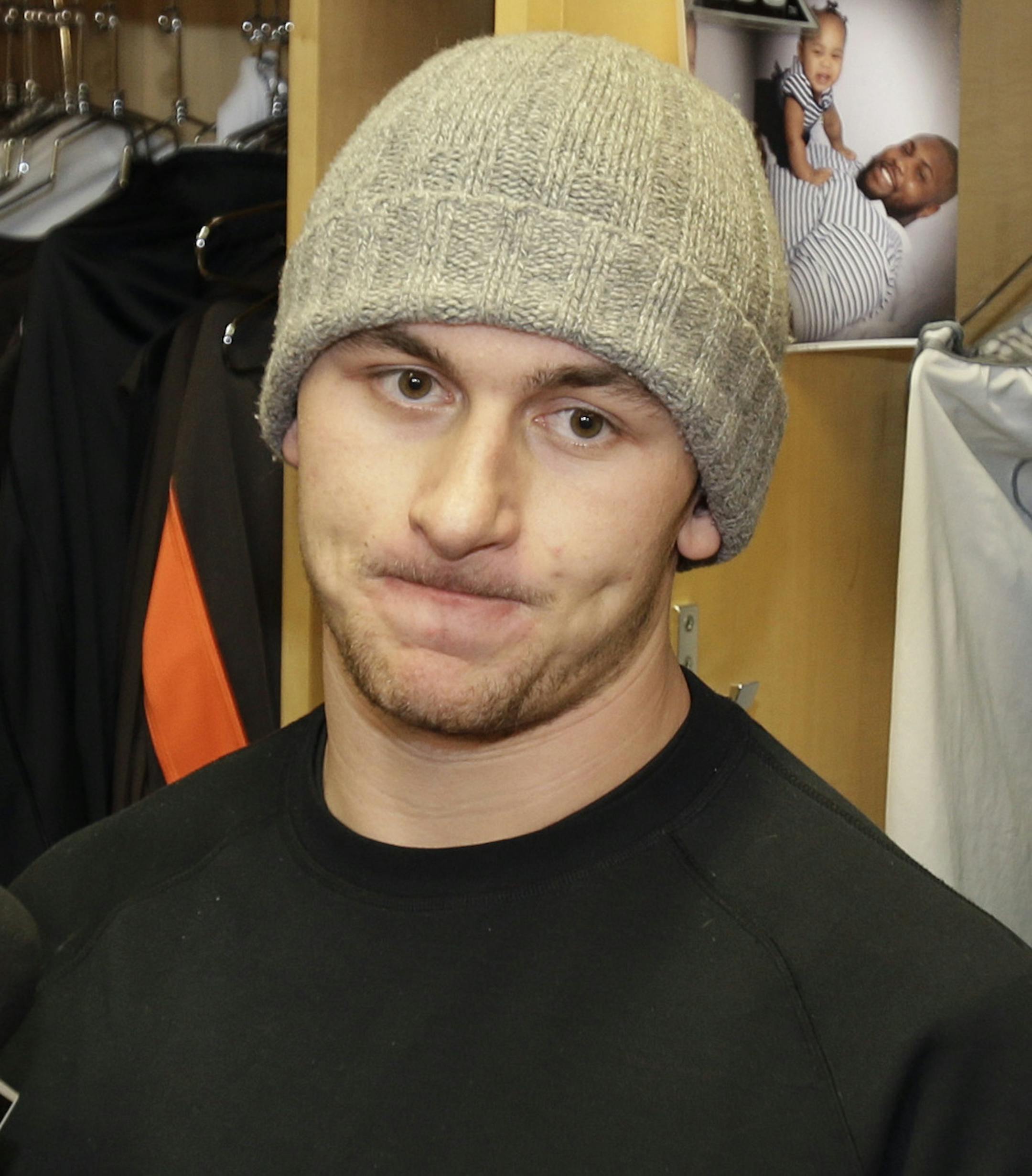 Cleveland Browns quarterback Johnny Manziel talks with the media at the NFL football team's training camp, Monday, Dec. 29, 2014, in Berea, Ohio. Along with key injuries and late-game collapses, the Browns' seventh straight losing season was undermined by the antics of wide receiver Josh Gordon, Manziel and cornerback Justin Gilbert. Owner Jimmy Haslam promised the organization will weed out any problem players. (AP Photo/Tony Dejak)