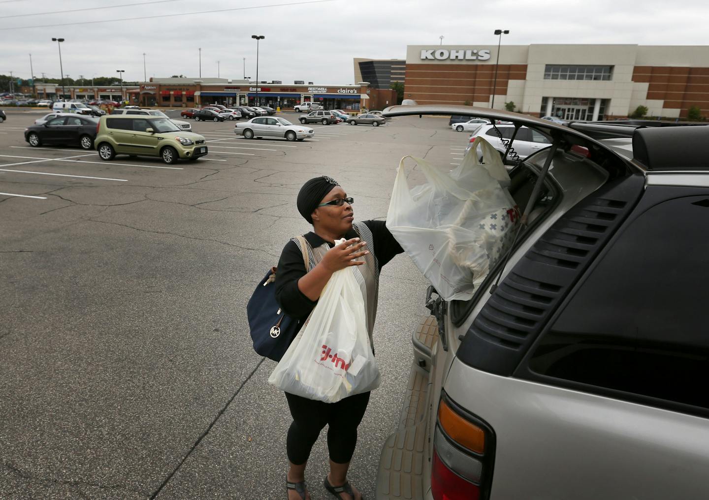 Susan Newell of Minneapolis placed bags in her vehicle after shopping at the Southtown Shopping Center in Bloomington on Tuesday afternoon. ] CARLOS GONZALEZ cgonzalez@startribune.com - September 9, 2014, Bloomington, Minn., Southtown was one of the Twin Cities' earliest suburban shopping centers, and it's always been happy to operate on a smaller scale than some of its competitors. But now the owner, Kraus -Anderson, says it's being "railroaded" by the city of Bloomington and the Met Council.