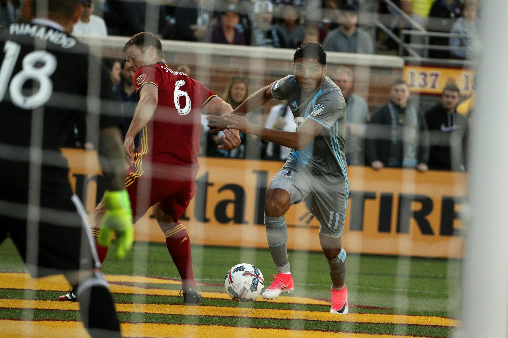 Minnesota United midfielder Johan Venegas (11) went around Real Salt Lake defender Justin Schmidt (6) to cross the ball in front of Real Salt Lake goalkeeper Nick Rimando (18) in the first half.