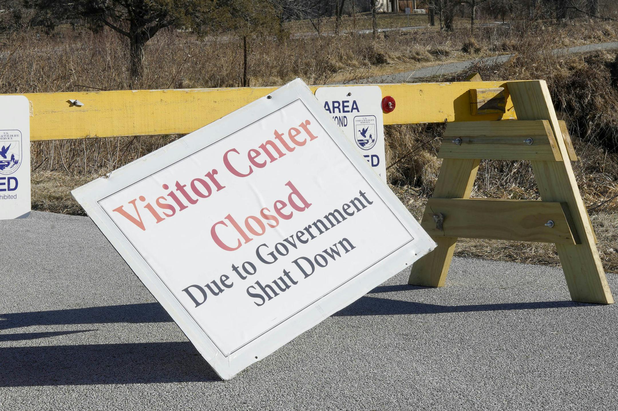 Signs announce the visitor center at the DeSoto National Wildlife Refuge in Missouri Valley, Iowa, is closed, Friday, Jan. 4, 2019, as the partial government shutdown continues. The U.S. Fish and Wildlife Service is directing dozens of wildlife refuges to return to work to make sure hunters and others have access despite the government shutdown, according to an email obtained Wednesday by The Associated Press. (AP Photo/Nati Harnik) ORG XMIT: WX105