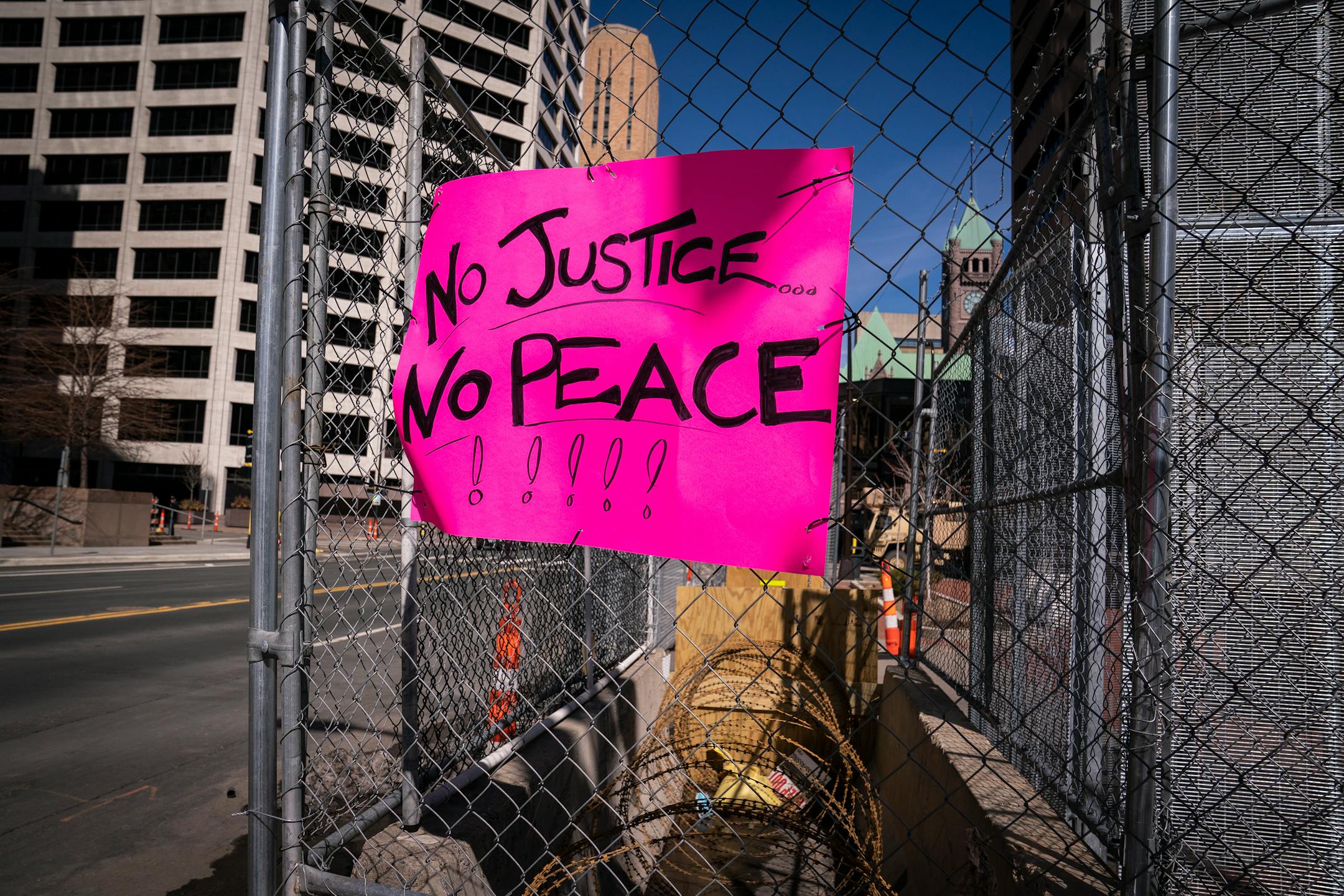 A sign was attached to a fence outside the Hennepin County Government Center.