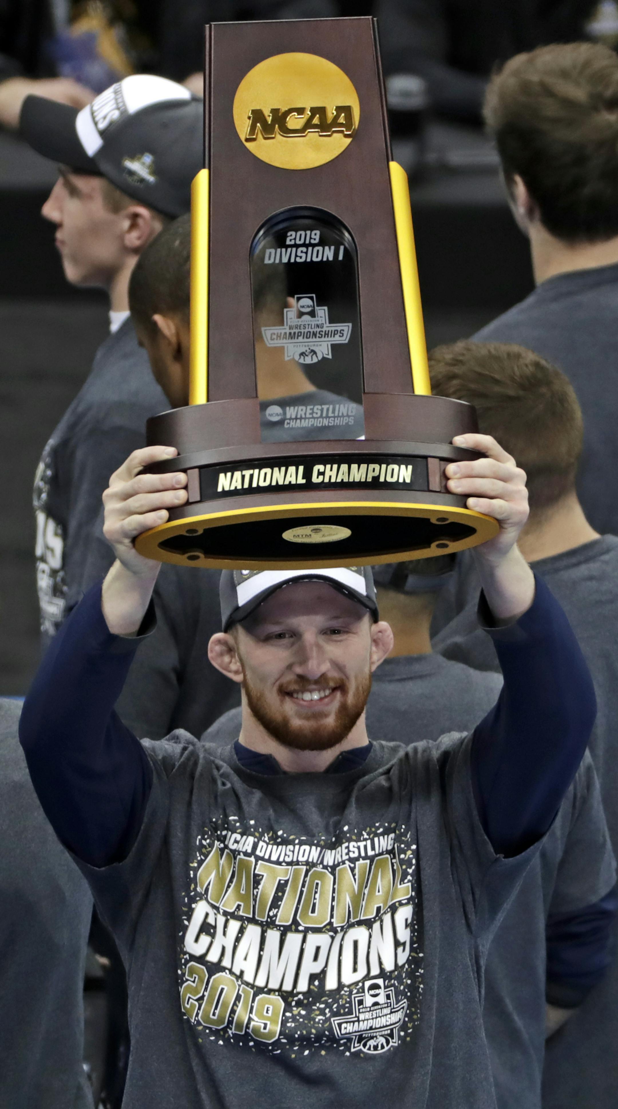 Penn State's Bo Nickal who won his 197-pound match against Ohio State's Kollin Moore in the finals of the NCAA wrestling championships, holds the team championship trophy that Penn State won for a record eighth time in nine years, Saturday, March 23, 2019 in Pittsburgh. (AP Photo/Gene J. Puskar)