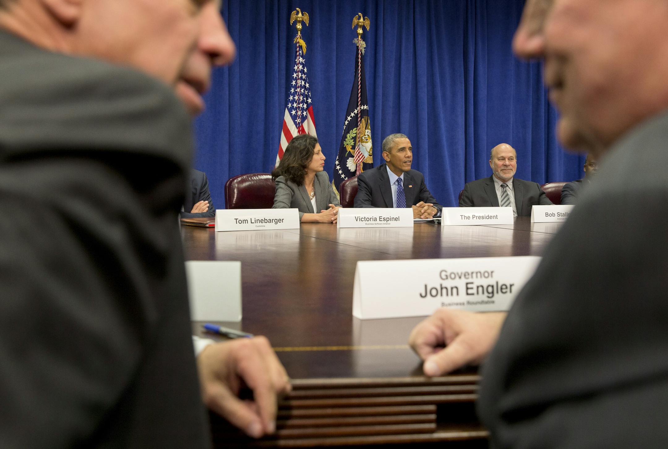 President Barack Obama sits next to Victoria Espinel, left, president and chief executive of the software industry trade group BSA, and Bob Stallman, right, president of the American Farm Bureau Federation, during a meeting with business leaders where the Trans-Pacific Partnership trade deal was discussed, at the Department of Agriculture in Washington, Oct. 6, 2015. Also pictured, in foreground, is: Arne Sorenson, left, president and chief executive of Marriott International and former Gov. Joh