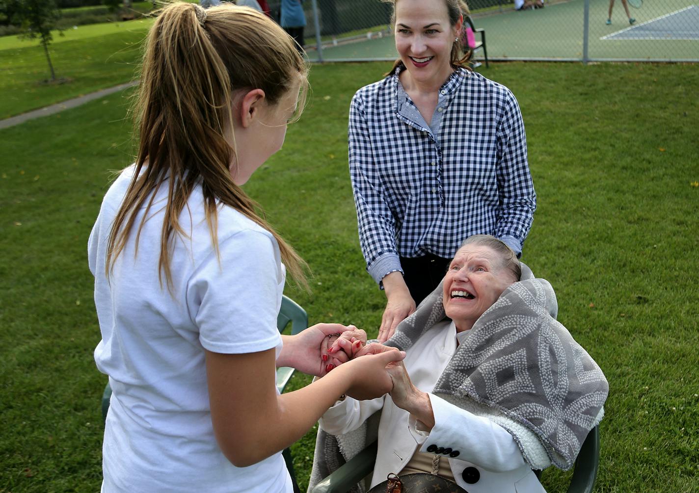 Elizabeth Radichel took her mother, Alice Tolzmann, 84, on a trip outside her assisted-living facility at English Rose Suites of Edina to watch Alice's granddaughter's tennis meet. The family was forced to move Alice, who has advanced Alzheimer's disease, suddenly last year after her mother wandered away the Waters on 50th in Edina and was threatened with eviction. Here, Alice Tolzmann, seated, greets her grand daughter Christina, 13, an 8th grader at Breck School, right, after they watched Chri