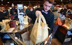Alec Voight bagged customers groceries at Kowalski's in Minneapolis on March 9, 2017. The Minneapolis City Council is delaying enforcement of its plas