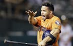Houston Astros' Jose Altuve celebrates after scoring against the Oakland Athletics in the tenth inning of a baseball game Thursday, Aug. 6, 2015, in O