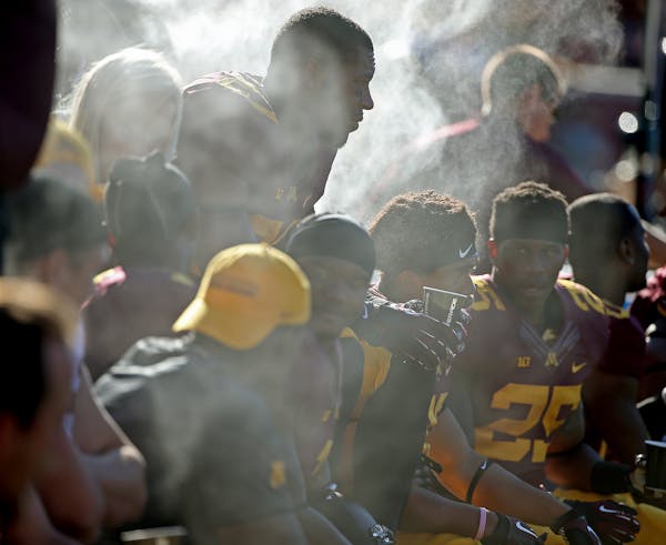 Minnesota players sat near fans blowing mist to keep cool as they took on Middle Tennessee at TCF Bank Stadium, Saturday, September 6, 2014 in Minneap