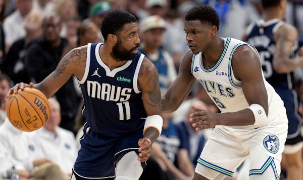 The Wolves' Anthony Edwards defends the Mavericks' Kyrie Irving in Game 1.