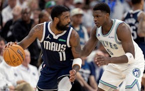 The Wolves' Anthony Edwards defends the Mavericks' Kyrie Irving in Game 1.