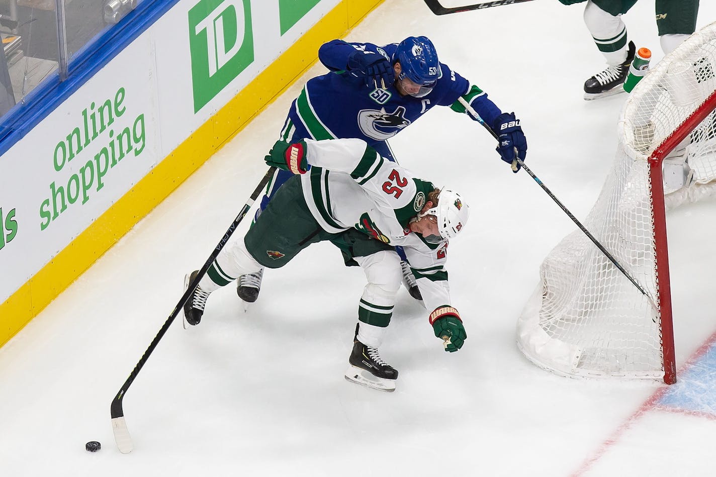 Minnesota Wild's Jonas Brodin (25) battles against Vancouver Canucks' Bo Horvat (53) during the first period of an NHL hockey playoff game Tuesday, Aug. 4, 2020 in Edmonton, Alberta. (Codie McLachlan/The Canadian Press via AP)