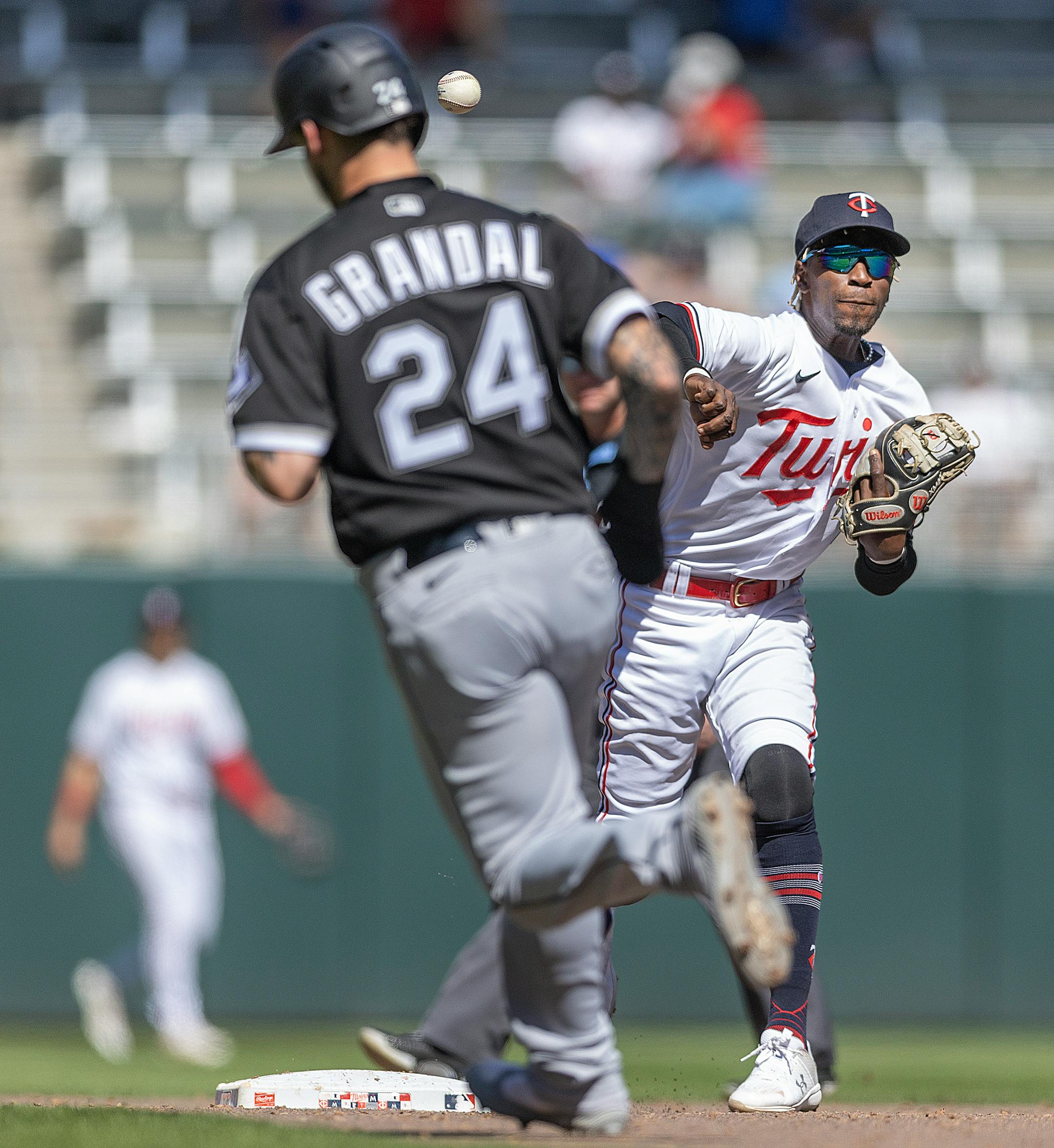 Minnesota Twins second baseman Nick Gordon (1) throws to first for a double play during the top of the ninth inning.