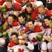 Team Canada celebrates with their gold medal after defeating the Americans 3 to 2 in overtime on a shot by superstar Sidney Crosby (right center).