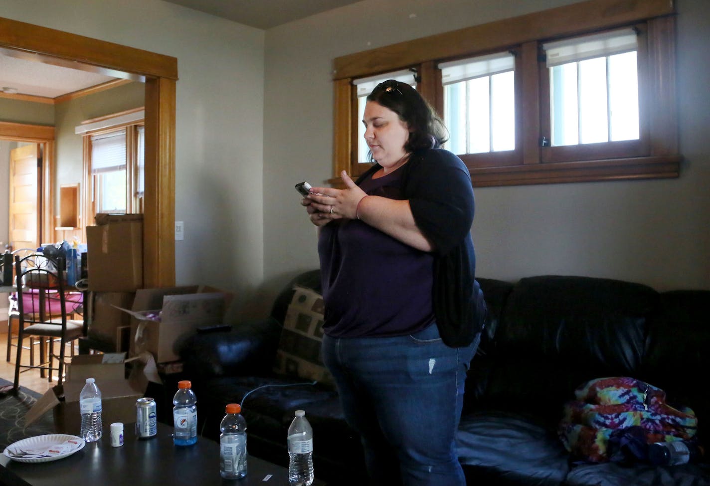 Jillian Nelson is among Uber customers who at times are having trouble getting rides in North Minneapolis. Here, Nelson monitored the progress of her Uber ride with her phone app while waiting for its arrival Wednesday, Aug. 5, 2015, at her northside Minneapolis, MN., home.](DAVID JOLES/STARTRIBUNE)djoles@startribune.com Jillian Nelson is among Uber customers who at times are having trouble getting rides in North Minneapolis. In the recent past, Nelson has ordered a ride from Uber, only to have