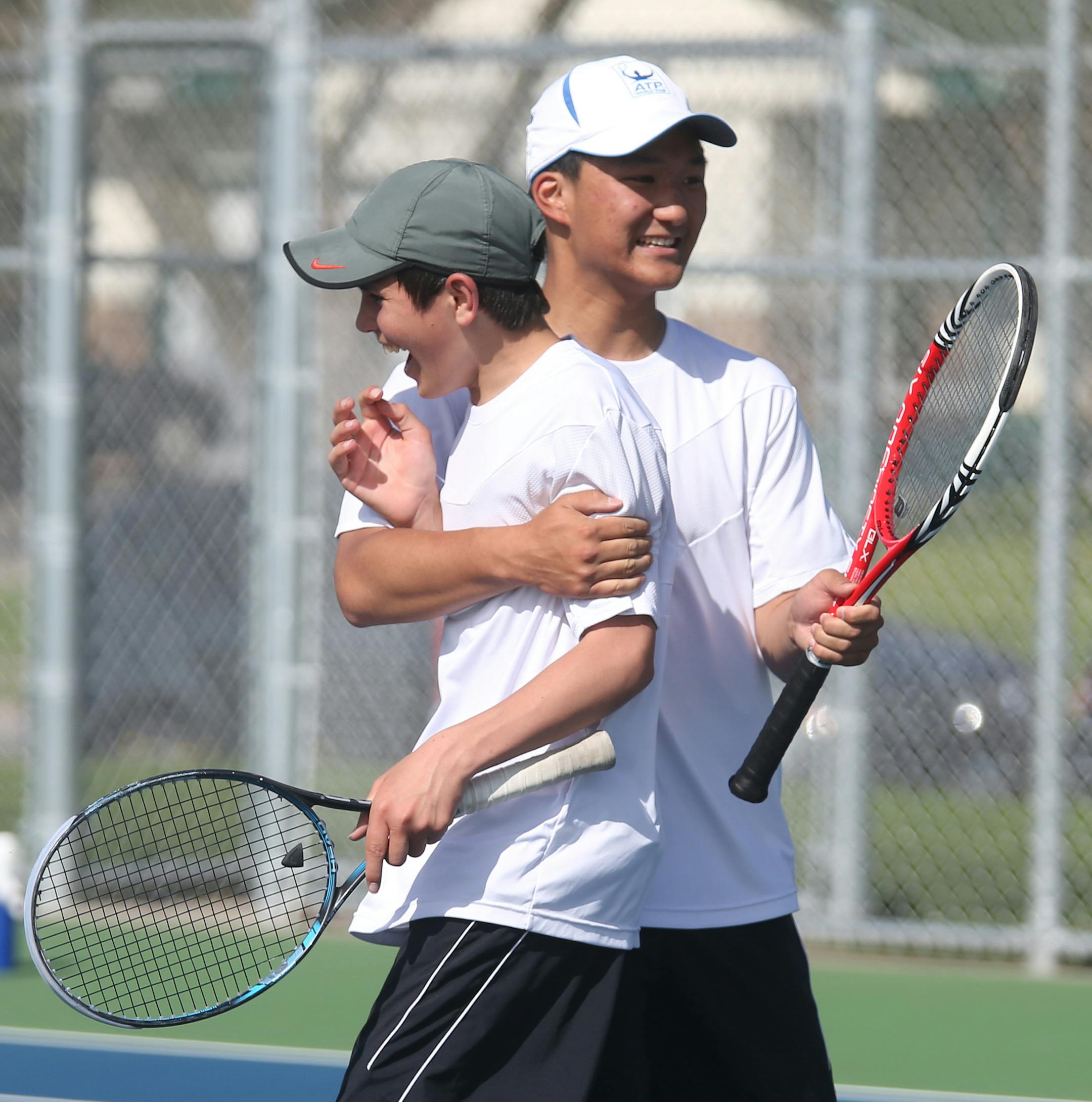 After winning their doubles match Petro Alex, left and Andrew Tang of Mounds View celebrated after finding out that his team won the meet and was going on to the state tournament. ] (KYNDELL HARKNESS/STAR TRIBUNE) kyndell.harkness@startribune.com Championship match of the Class 2A, Section 5 boys' tennis tournament at Park Center High School in Brooklyn Park, Min. Tuesday, May 20, 2014.
