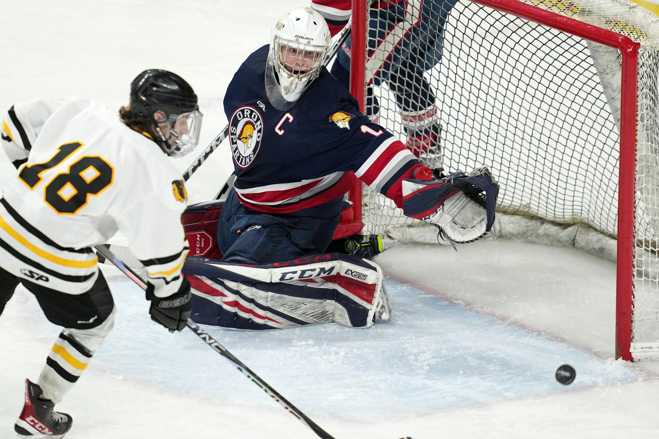Warroad forward Carson Pilgrim (18) shoots the puck wide of Orono goaltender Brock Peyton (1) in the second period.