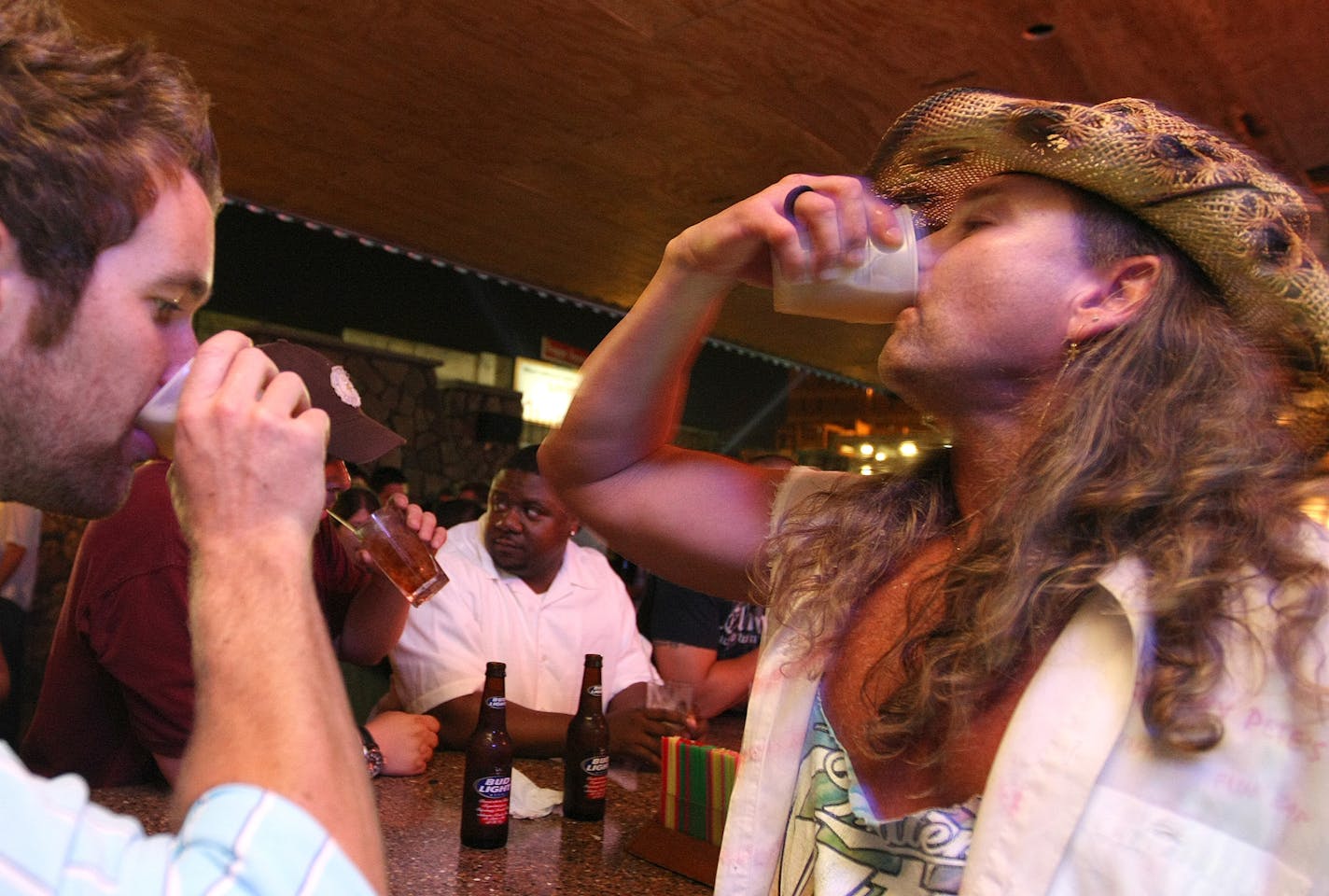 One of downtown's hottest party bars, Sneaky Pete's, in 2008. It's a pretty wild place that recently added some new fun stuff, including a nice downstairs party area and a vollyball court in the back parking lot. The legend barkeep Jake Stone, on right, shares the drink, Wild Shocker, with regular and beer salesman, Jimmy Morrissey.