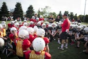Sixth grade commissioner Sal Fialo talk to the players during a scrimmage practice at Eden Prairie High School in Eden Prairie, Minn., on Tuesday, Aug