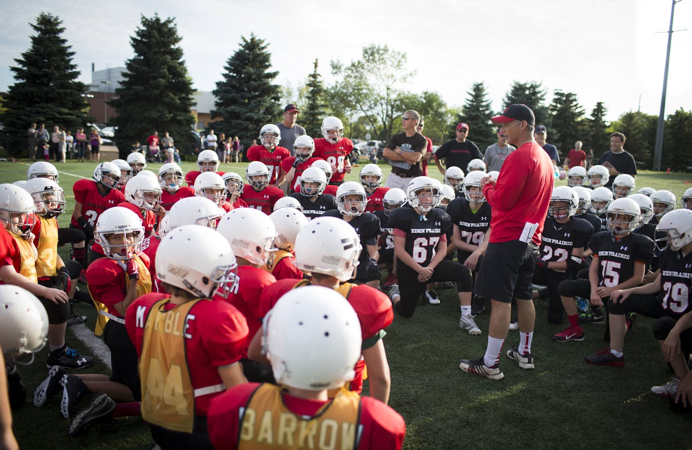 Sixth grade commissioner Sal Fialo talk to the players during a scrimmage practice at Eden Prairie High School in Eden Prairie, Minn., on Tuesday, August 26, 2014. Minnesota&#x2019;s premiere football program is hurting &#x2013; fewer boys are signing up to play football. Mike Grant, the high school&#x2019;s iconic coach, said there are 10 percent fewer players this year on his varsity team. The sixth grade team has 72 players this year, 12 less than last year. ] RENEE JONES SCHNEIDER &#x2022; r