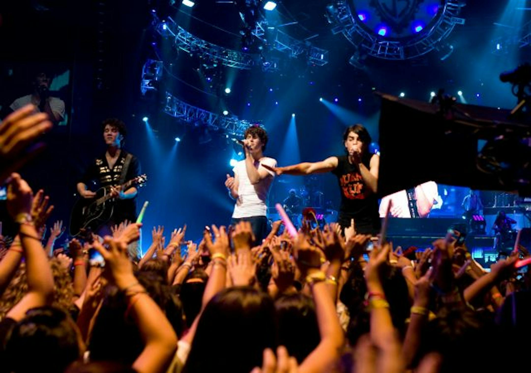 In this image released by Disney, the Jonas Brothers, from left, Kevin Jonas, Nick Jonas, Joe Jonas perform in a "Jonas Brothers: The 3D Concert Experience."