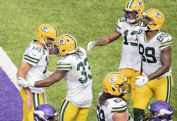Green Bay Packers quarterback Aaron Rodgers, left, celebrated a touchdown with Green Bay Packers running back Aaron Jones during the fourth quarter.