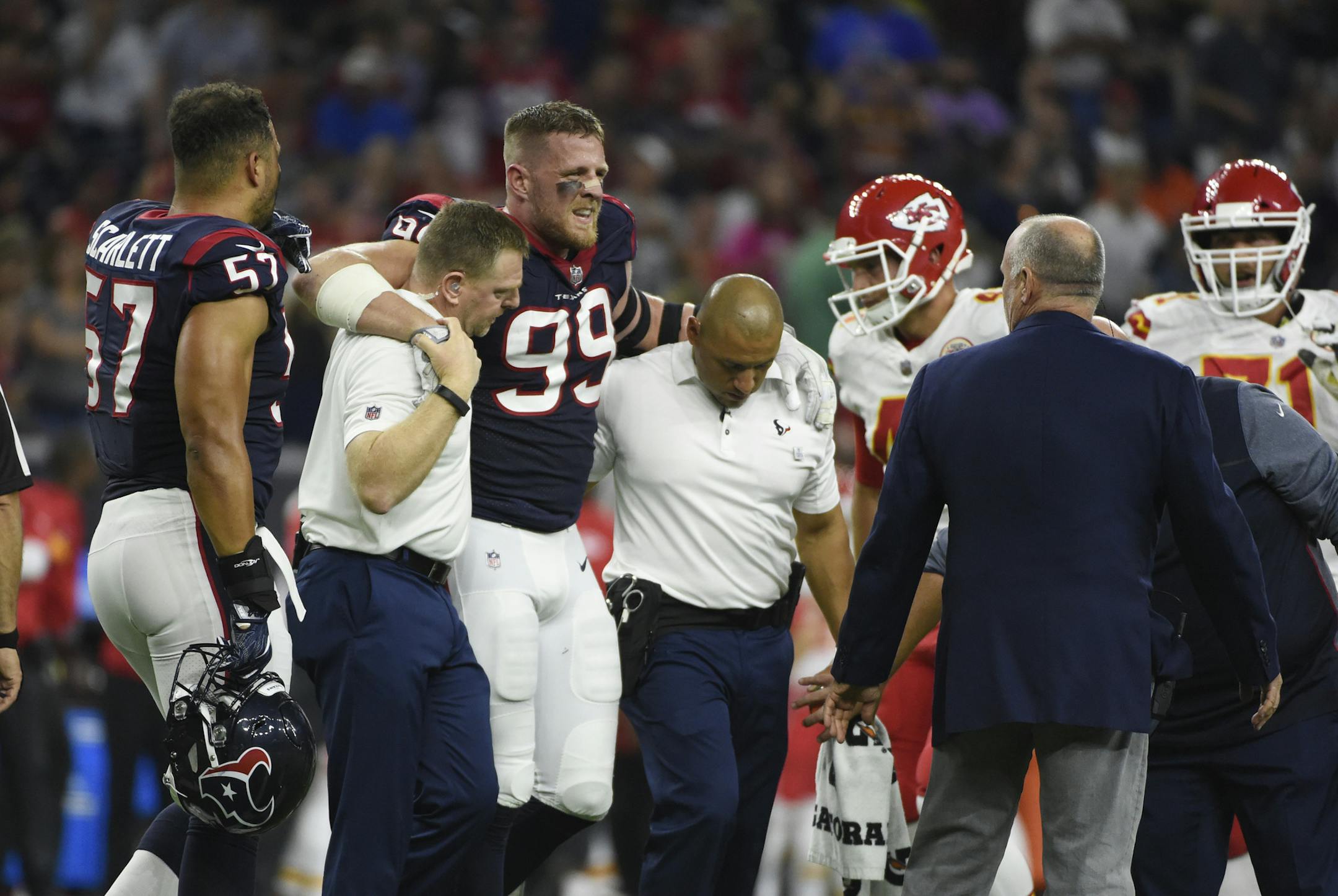 Houston Texans defensive end J.J. Watt (99) is helped off the field after an injury during the first half of an NFL football game Sunday, Oct. 7, 2017, in Houston. (AP Photo/Eric Christian Smith)