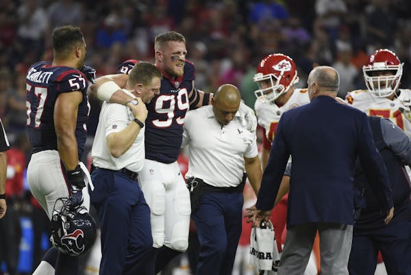 Houston Texans defensive end J.J. Watt (99) is helped off the field after an injury during the first half of an NFL football game Sunday, Oct. 7, 2017
