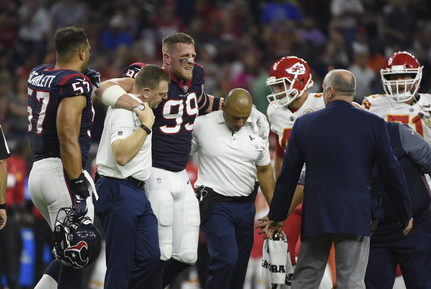 Houston Texans defensive end J.J. Watt (99) is helped off the field after an injury during the first half of an NFL football game Sunday, Oct. 7, 2017, in Houston. (AP Photo/Eric Christian Smith)