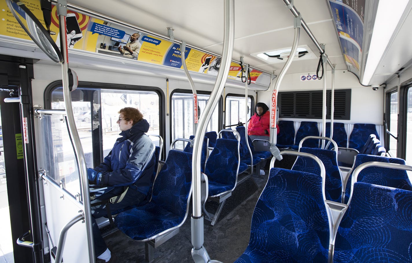 David White, left, and Lamont Butler, center, rode the A-line bus departing the 46th Street Blue Line light rail station on Friday.