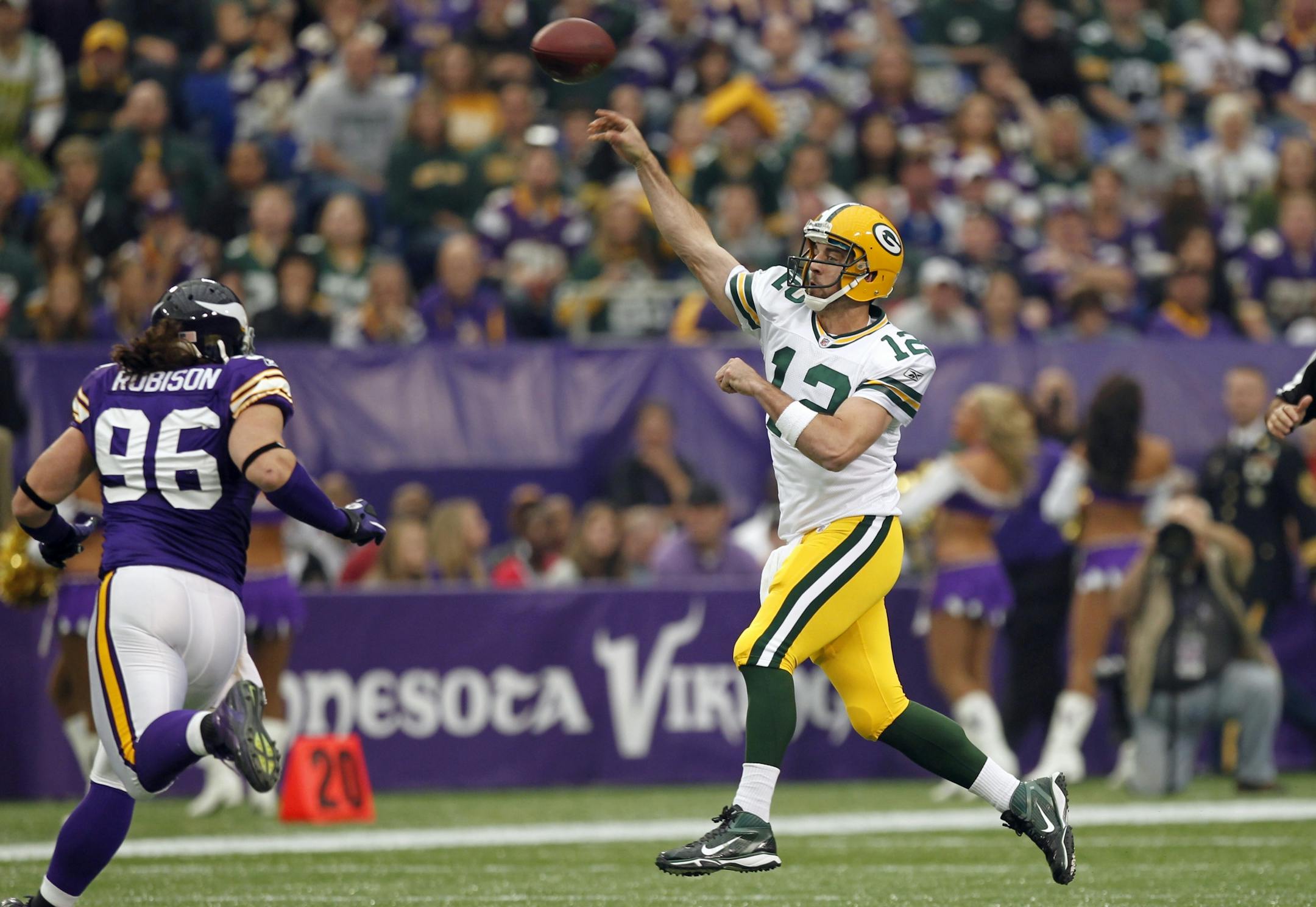Packers quarterback Aaron Rodgers threw a pass over Vikings defensive end Brian Robison during the first half of Green Bay's 33-27 victory Sunday.
