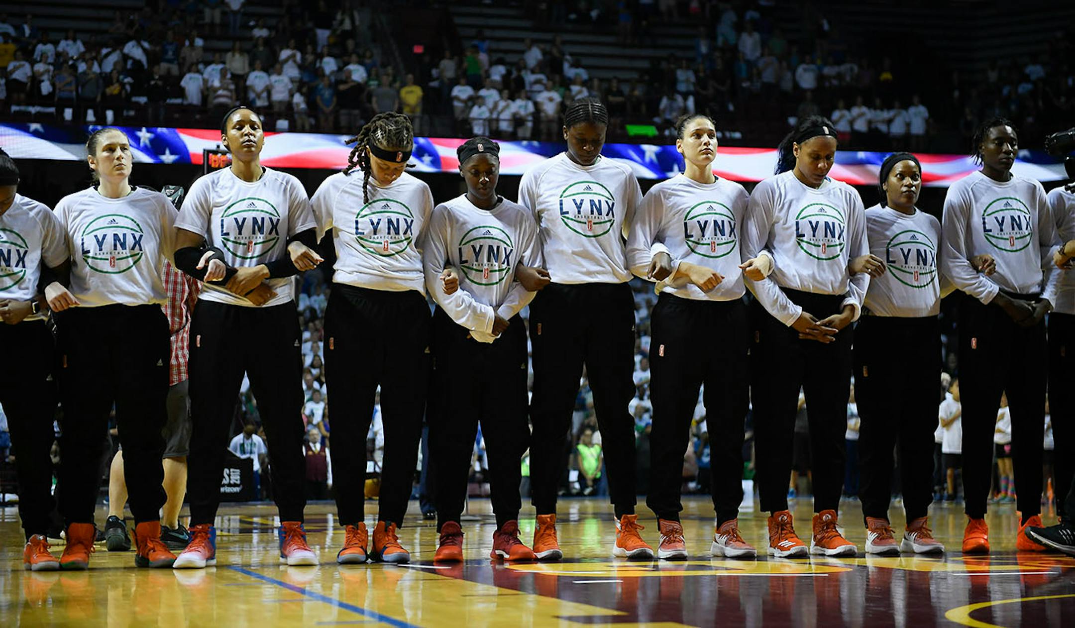 Minnesota Lynx players linked their arms during the national anthem Sunday night before game one of the WNBA Championships against the Los Angeles Sparks.