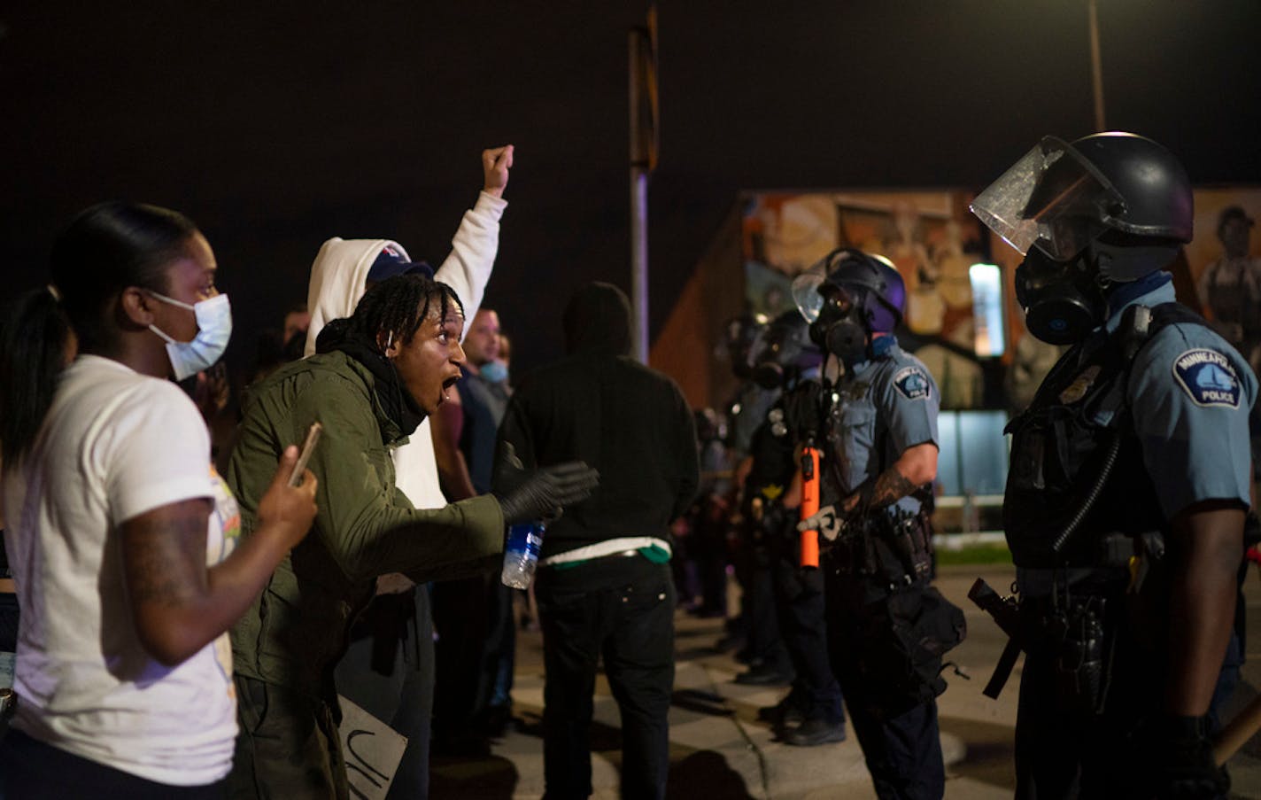 Demonstrators confronted Minneapolis police trying to push them south on Minnehaha Ave. late Wednesday night.