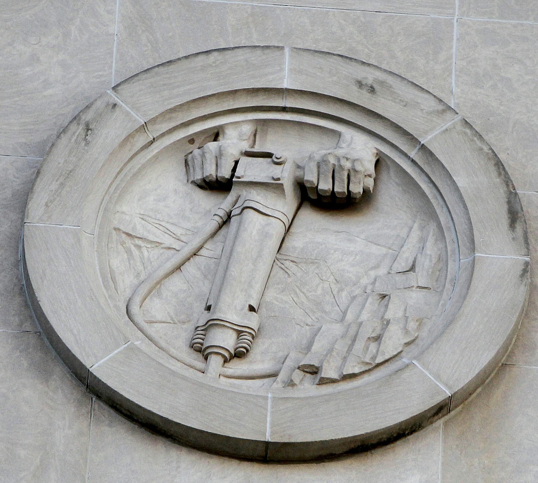 Construction crew from Ryan were beginning the process of removing medallions from front of Star Tribune building, Monday, February 10, 2014 in Minneapolis, MN. ] (ELIZABETH FLORES/STAR TRIBUNE) ELIZABETH FLORES • eflores@startribune.com