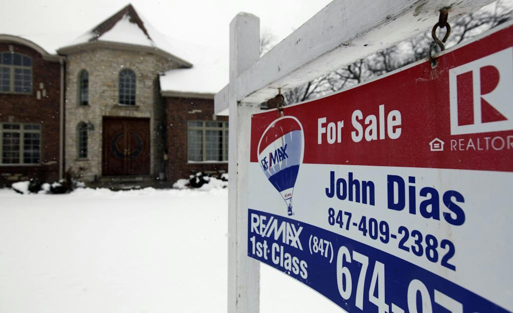 In this Wednesday, Feb. 27, 2013, photo, a "for sale" sign is seen outside a home in Glenview, Ill., Average U.S. rates on fixed mortgages moved closer to historic lows this week, a trend that has helped drive a rebound in home sales.