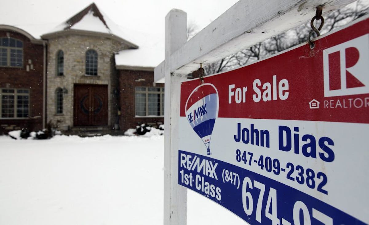 In this Wednesday, Feb. 27, 2013, photo, a "for sale" sign is seen outside a home in Glenview, Ill., Average U.S. rates on fixed mortgages moved close