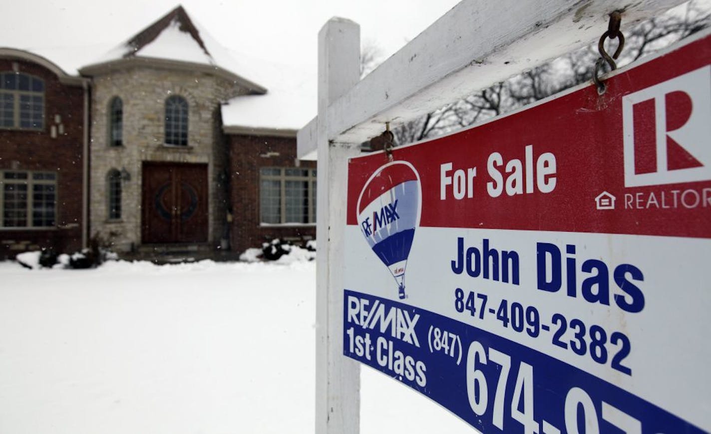 In this Wednesday, Feb. 27, 2013, photo, a "for sale" sign is seen outside a home in Glenview, Ill., Average U.S. rates on fixed mortgages moved closer to historic lows this week, a trend that has helped drive a rebound in home sales.