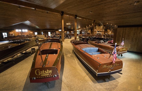 A 1929 28-foot Garwood Triple-Cockpit Runabout and a 1928 26-foot Dodge Triple-Cockpit Runabout. The boats are part of a collection belonging to John 