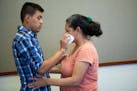 Steve Hernandez wipes a tear from his mother's eye after seeing her for the first time in 20 years in San Diego, Calif., on Thursday, June 9, 2016. St